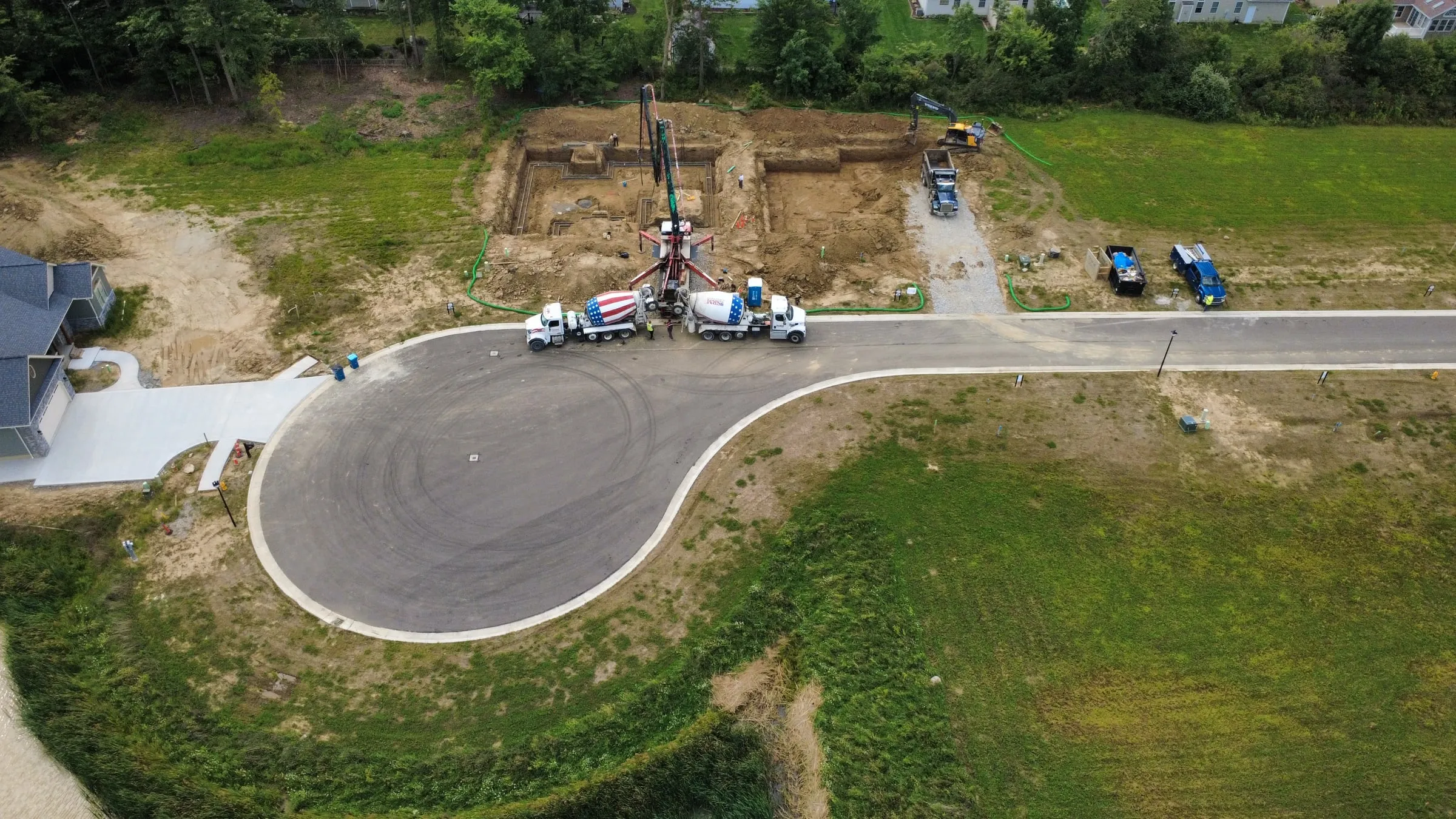 Aerial view of concrete trucks working at the end of a new cul-de-sac