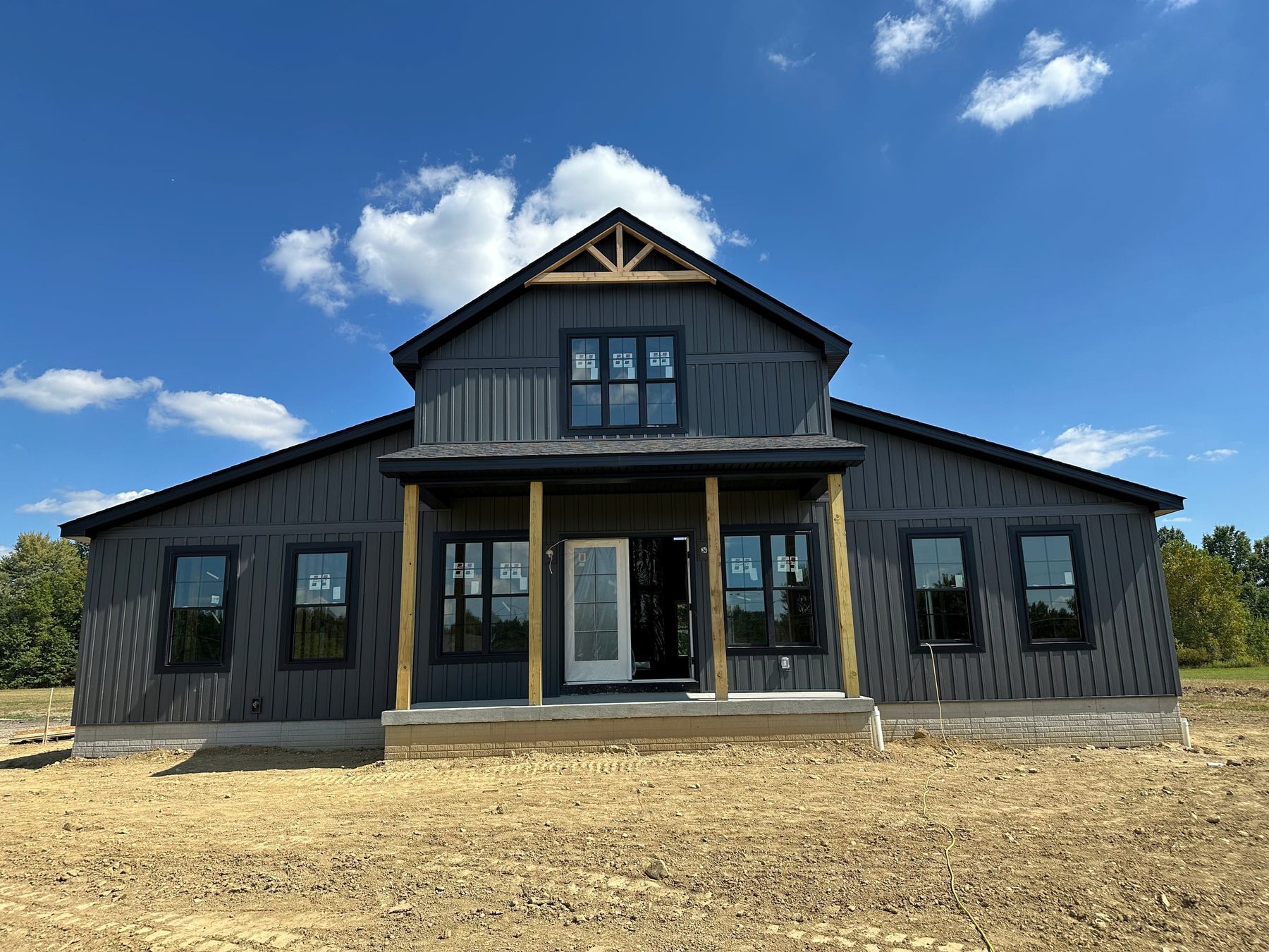 Black modern farmhouse with a covered front porch