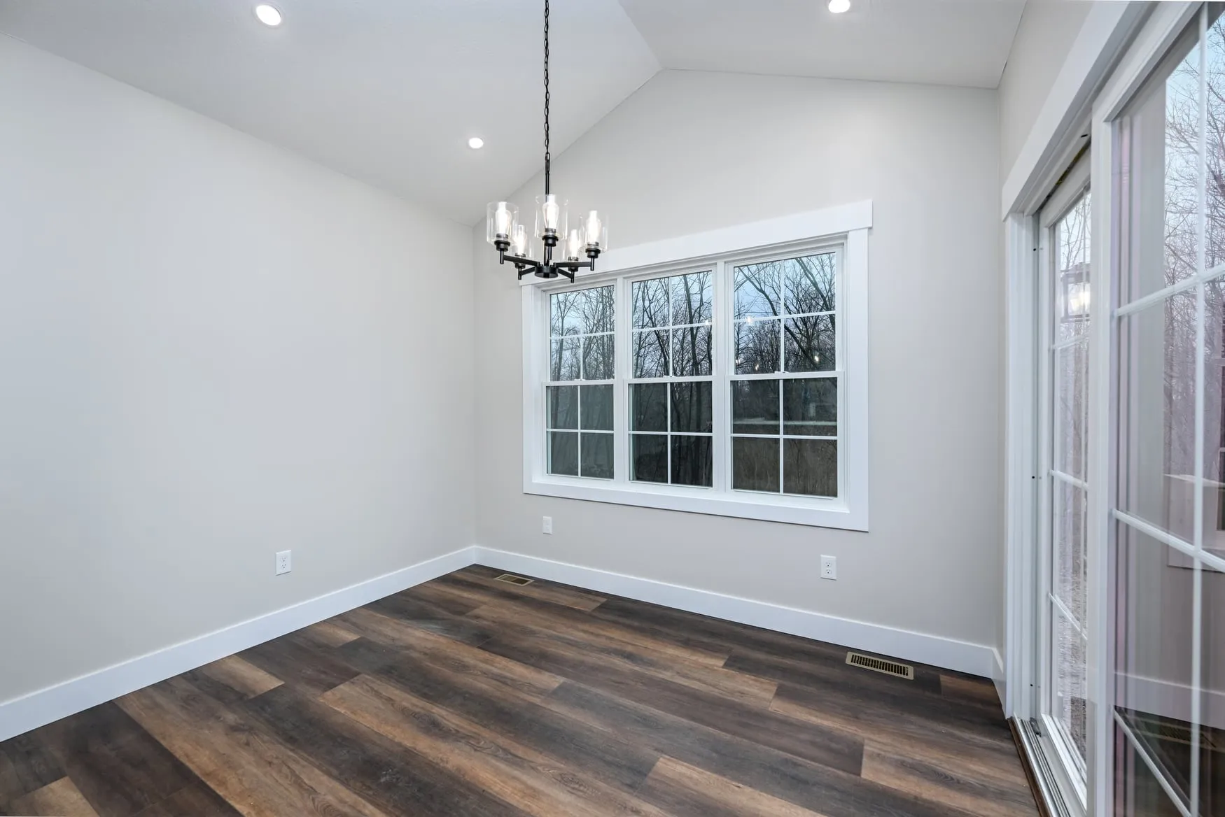 Dining area with a chandelier and tall windows