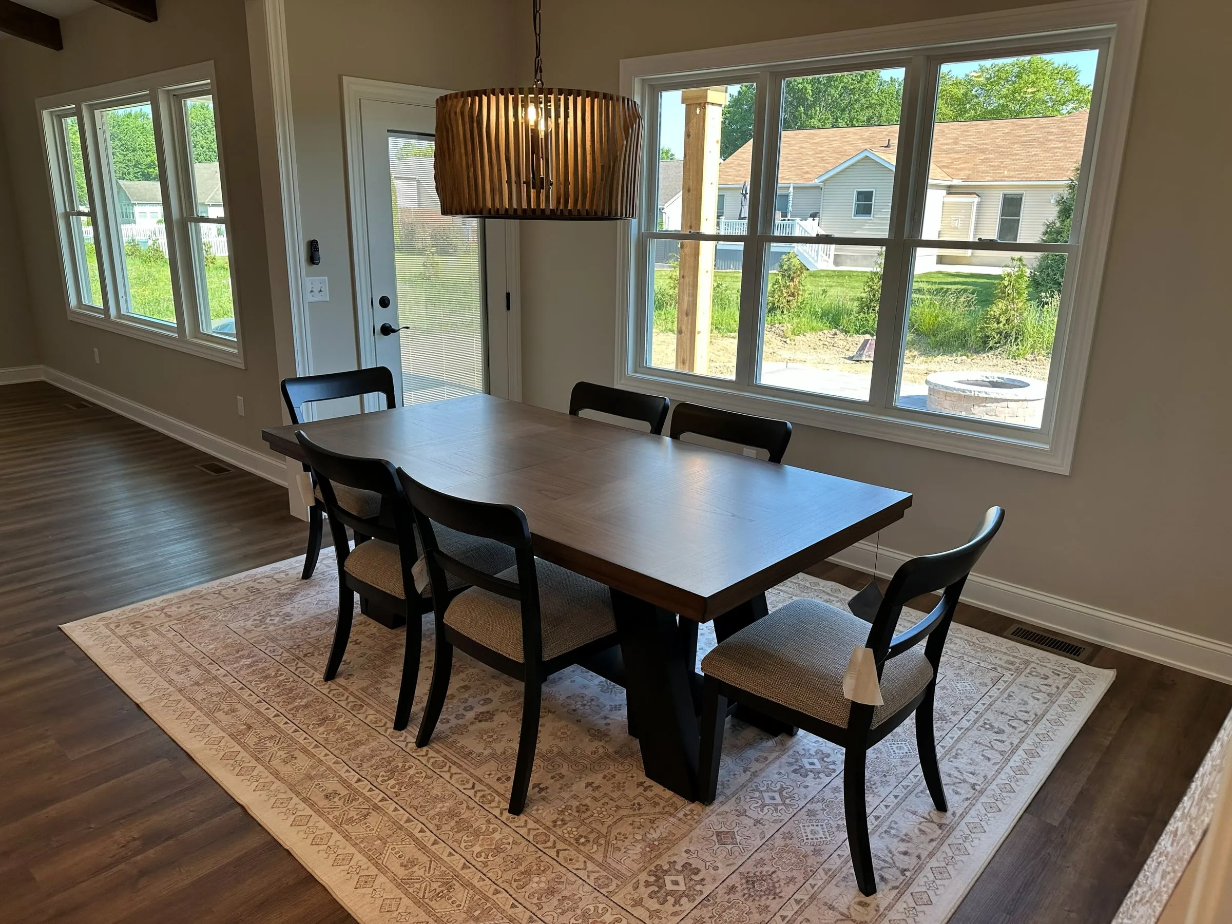 Model home dining area with a woven pendant light
