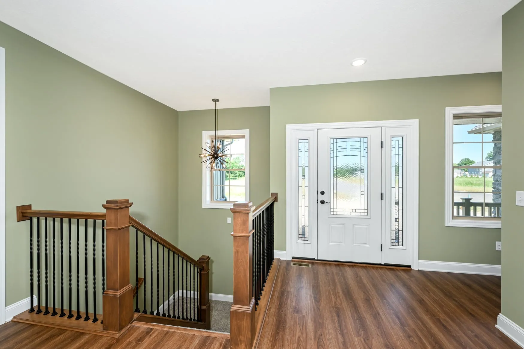 Entry with an open staircase and glass front door