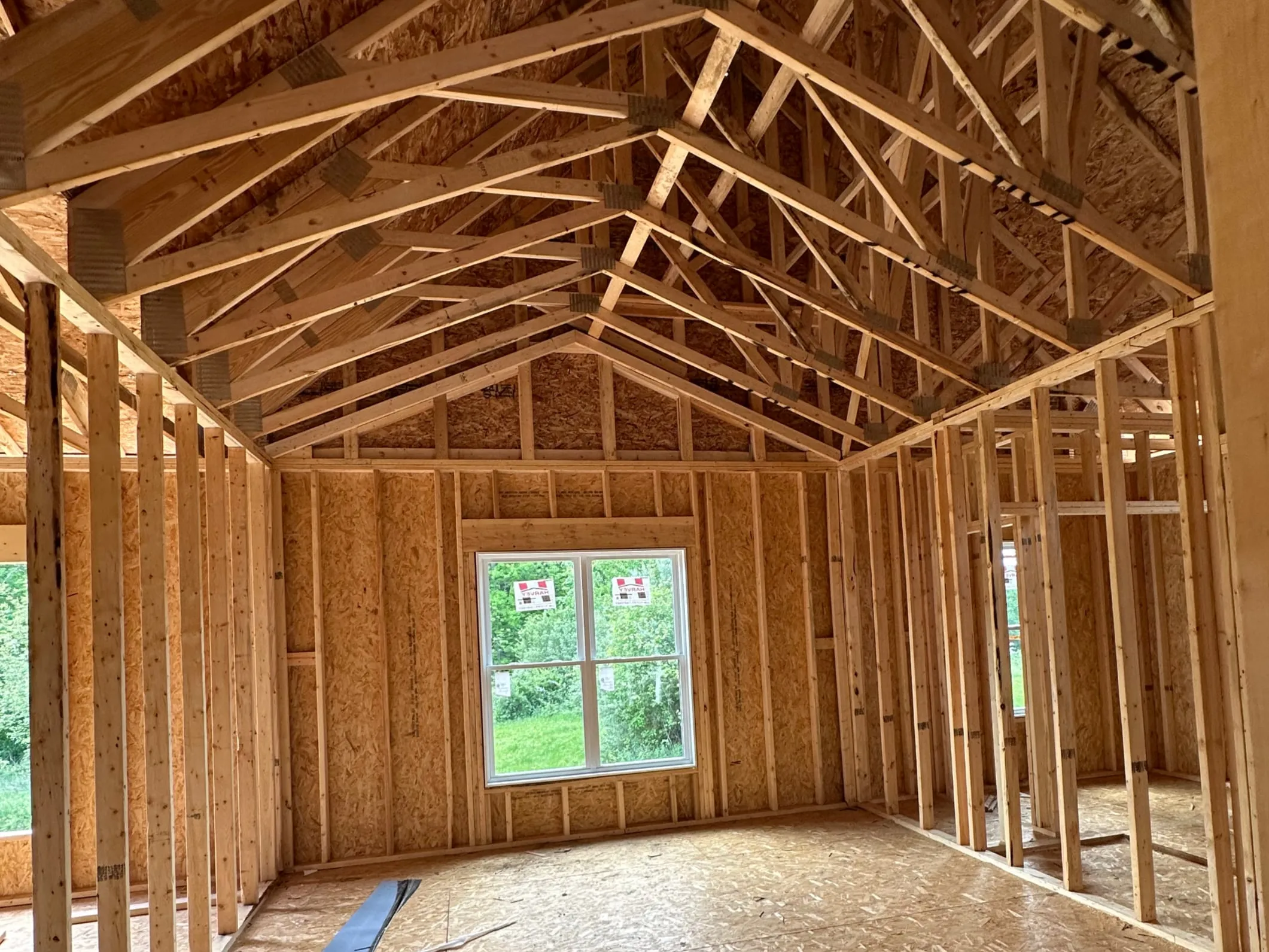 Interior framing of a new home with sunlight through the window openings