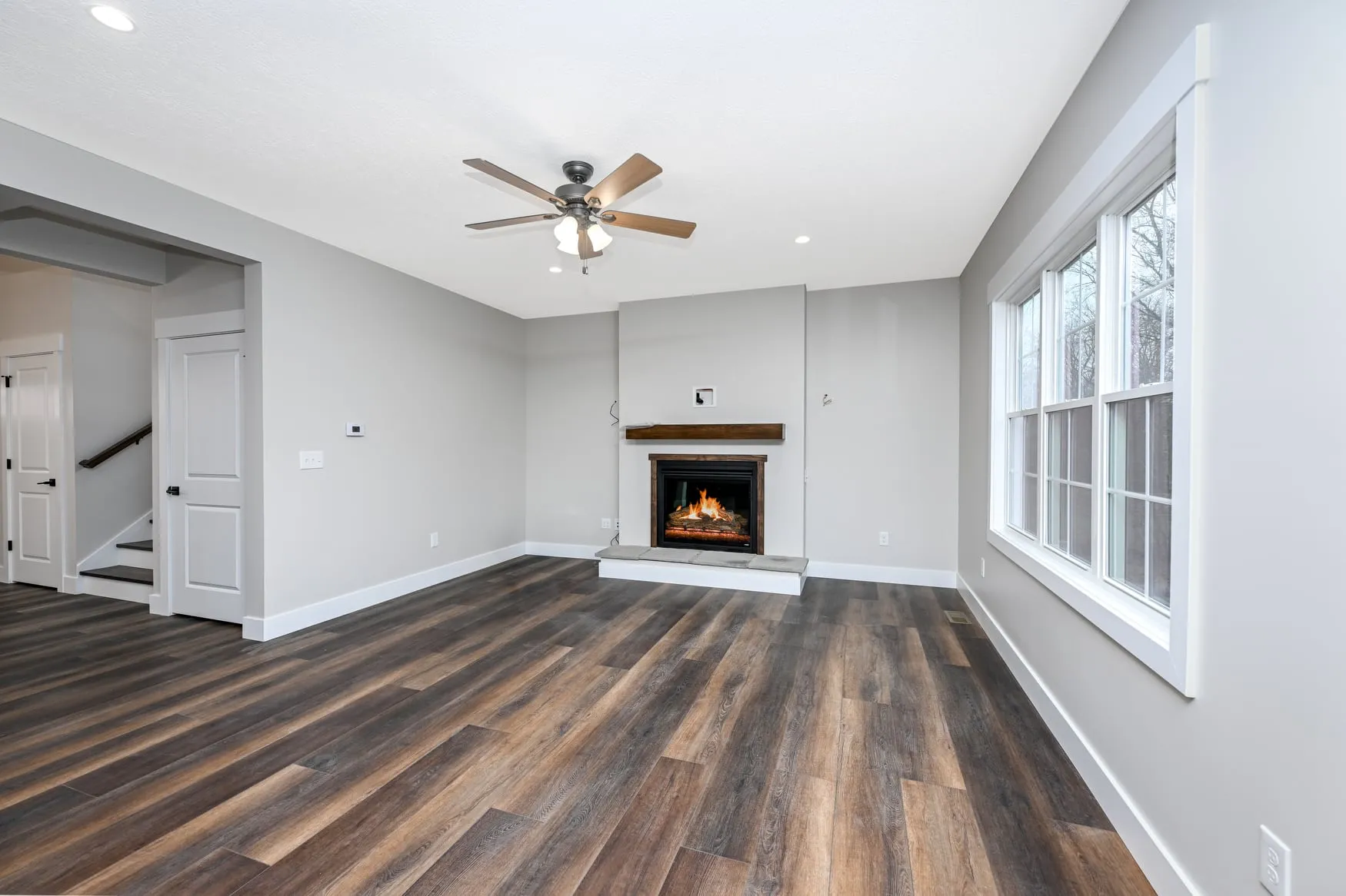 Great room with a fireplace and vaulted ceiling