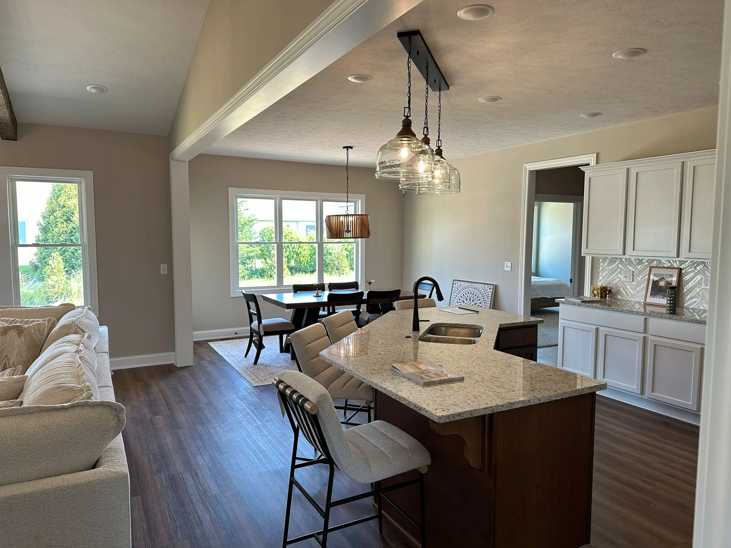 Model home kitchen and dining under a vaulted ceiling