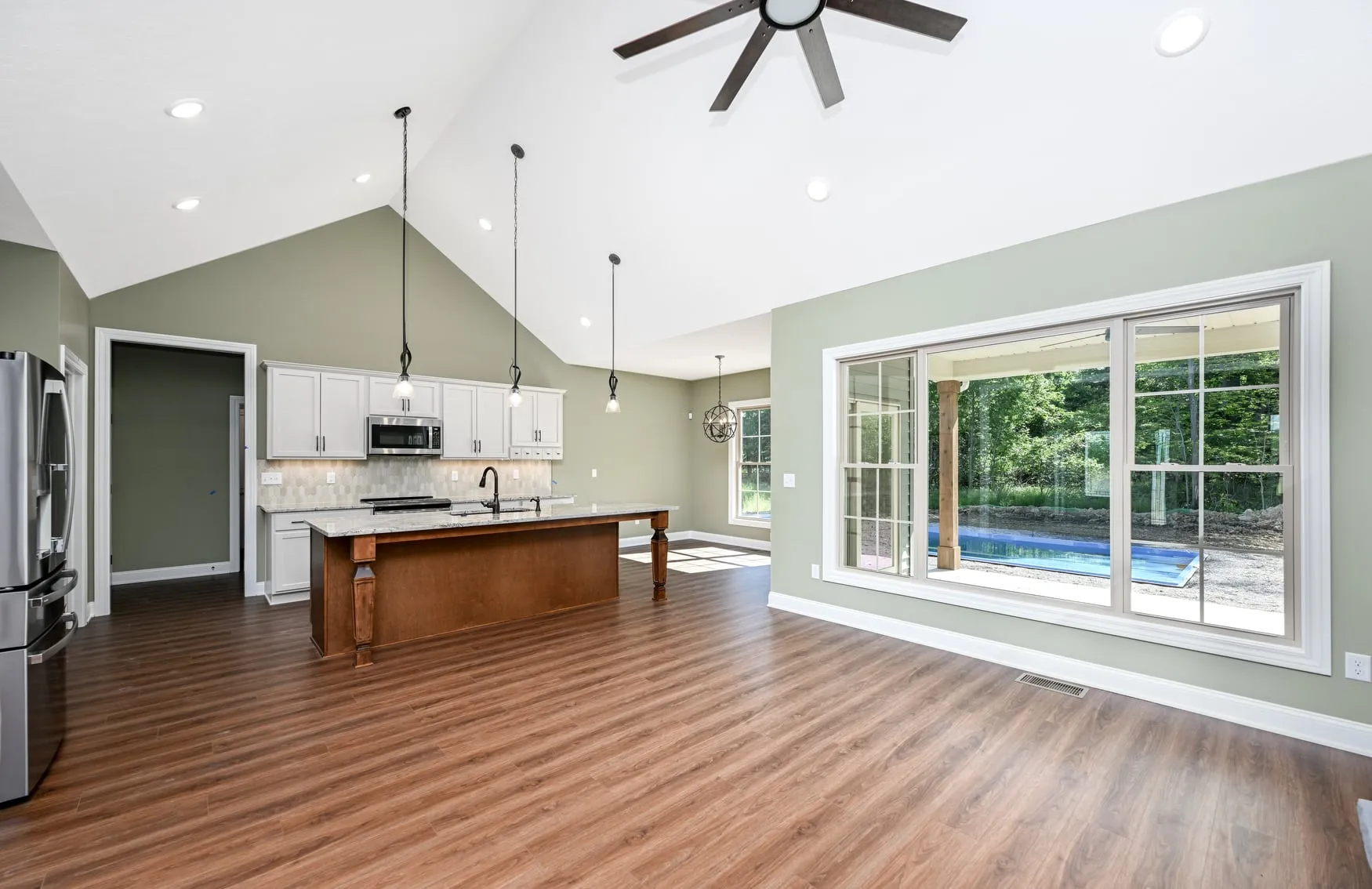 Kitchen and great room under a vaulted ceiling