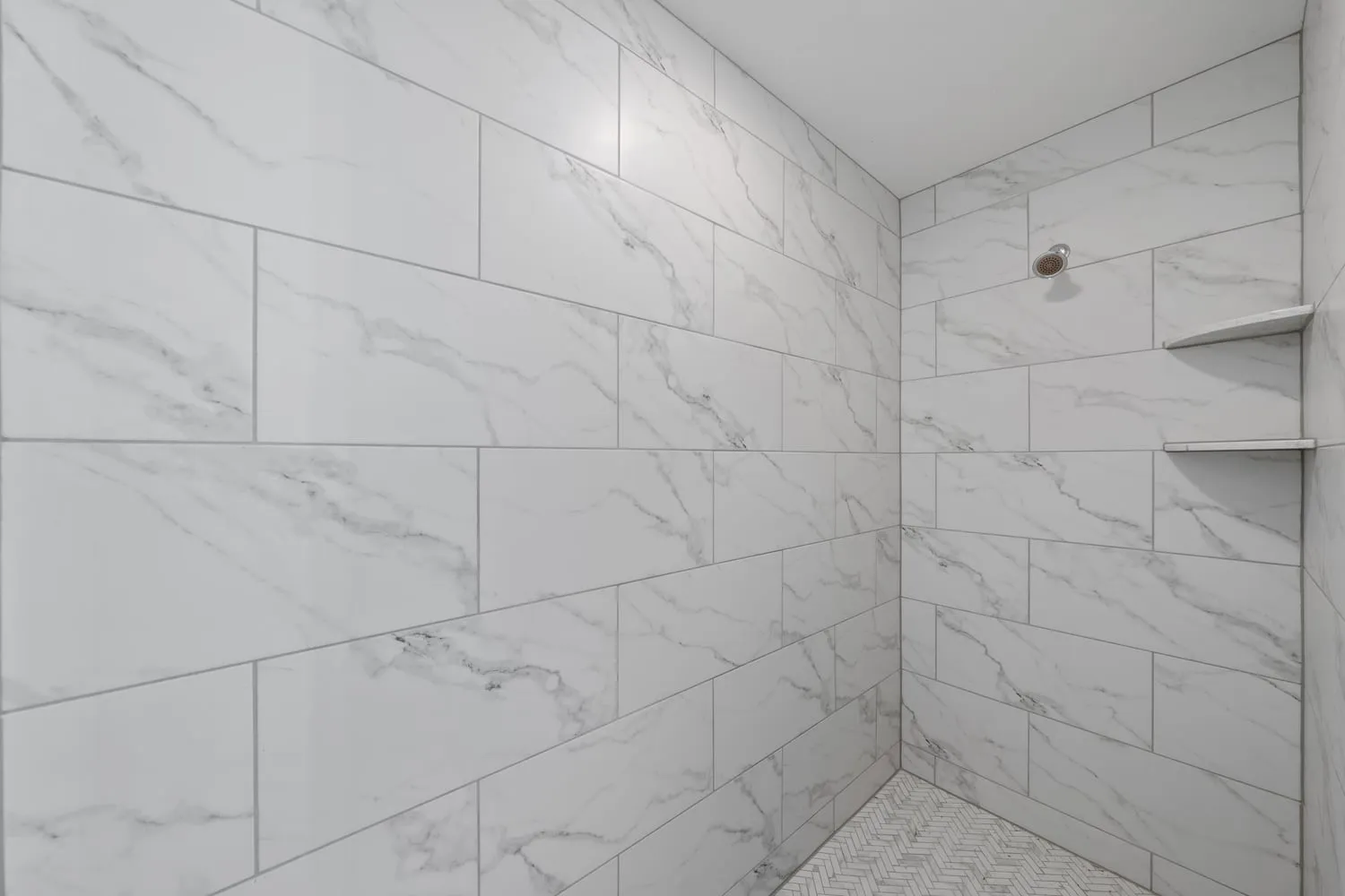 Marble-look tiled walk-in shower