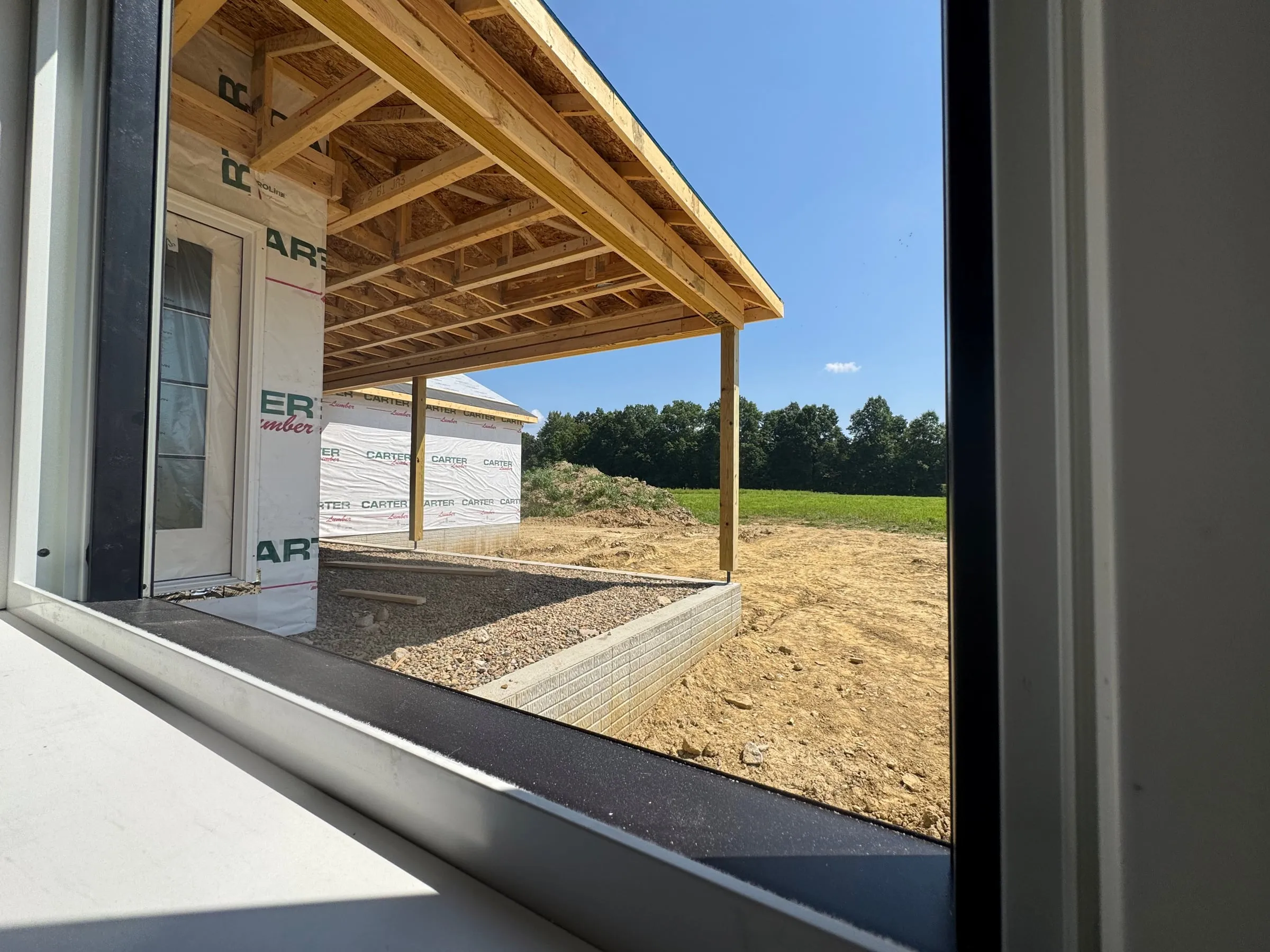 View through a framed doorway to the covered porch