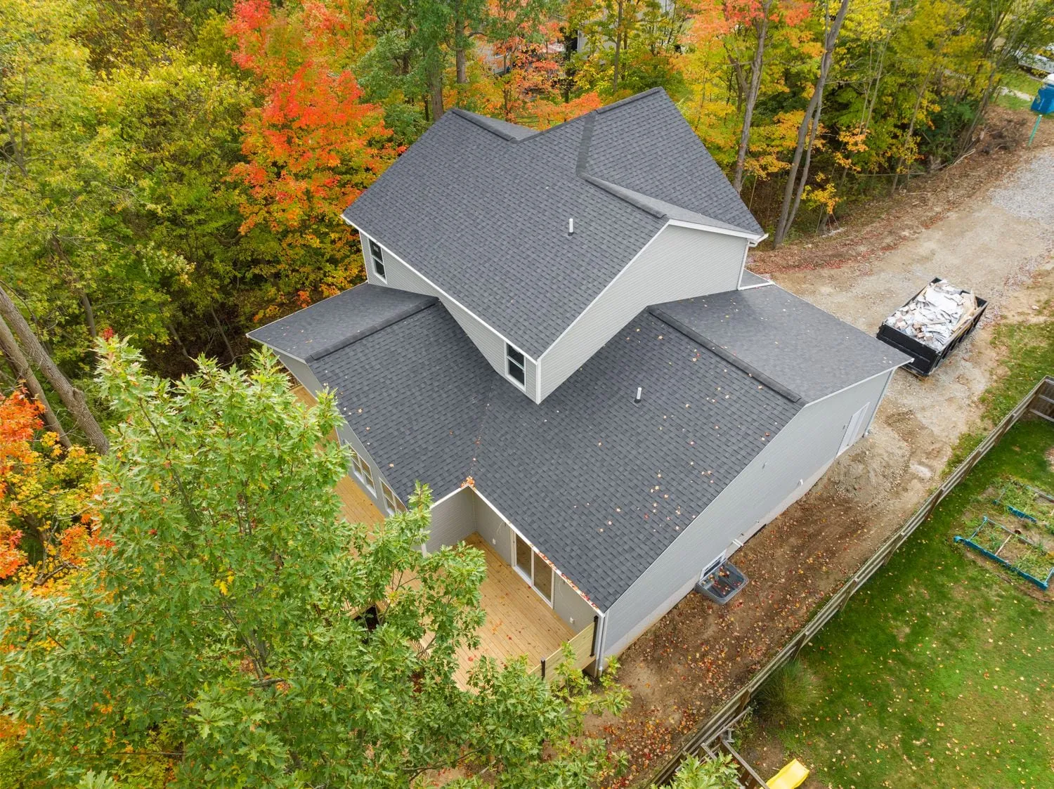 Aerial view of a two-story home among autumn trees