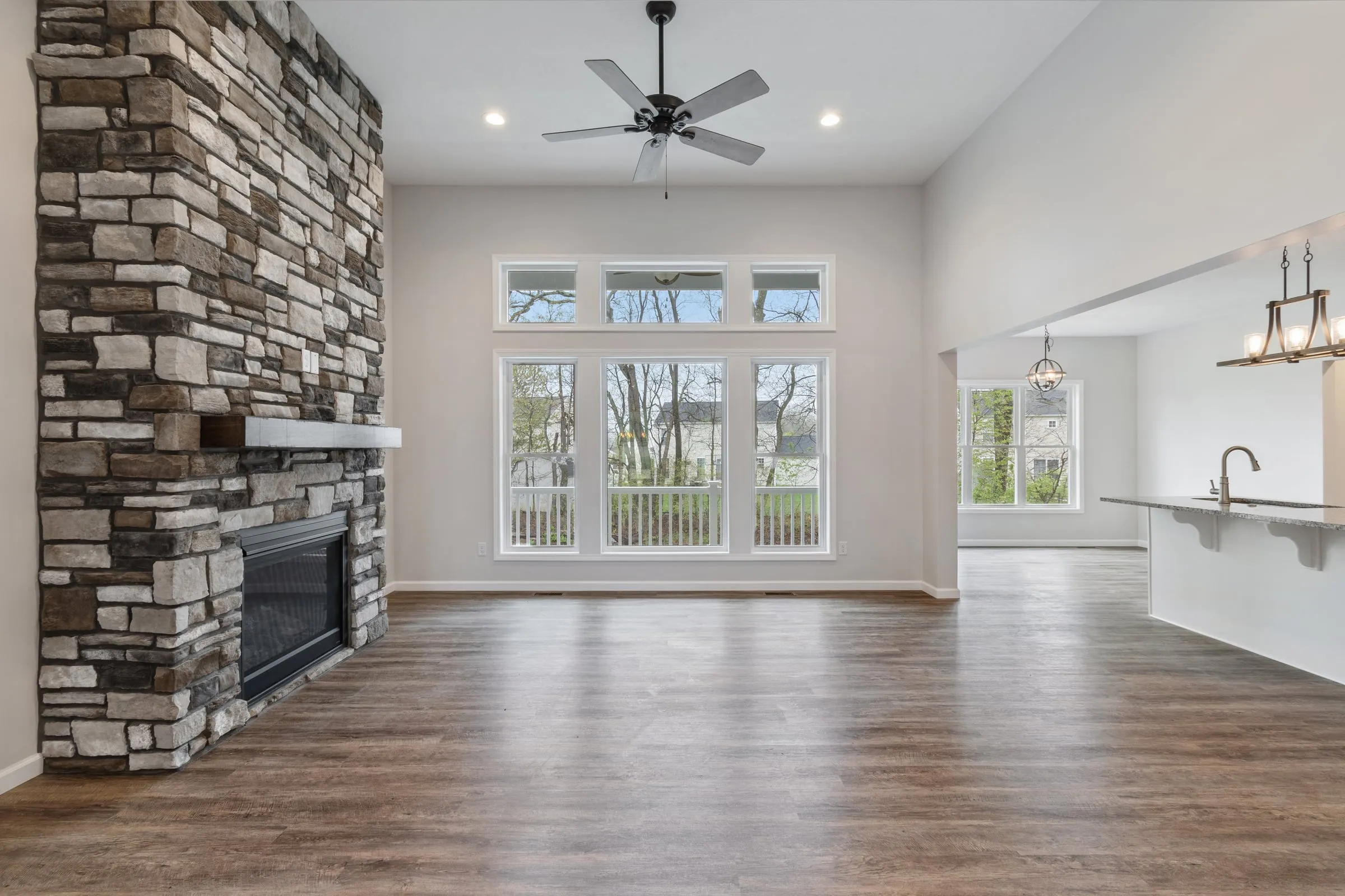 Great room with floor-to-ceiling stone fireplace and vaulted ceiling